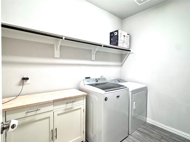 7204 Silent Mill Rd, Arlington, TX 76001 - laundry area with washer and dryer, light wood-type flooring, and cabinet space