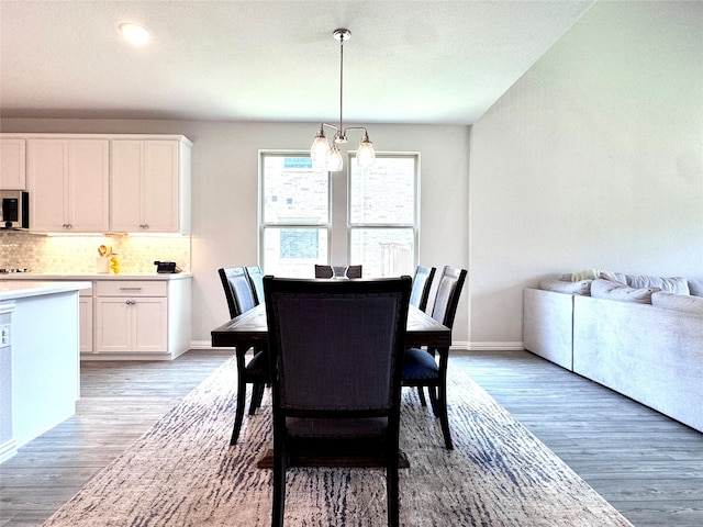 7204 Silent Mill Rd, Arlington, TX 76001 - dining room featuring a chandelier and light wood-style flooring