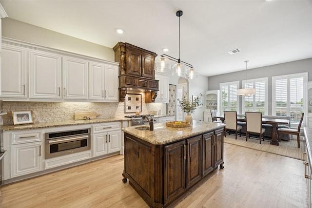 1300 Aberdeen Dr, Lucas, TX 75002 - kitchen with oven, white cabinetry, dark brown cabinetry, and recessed lighting