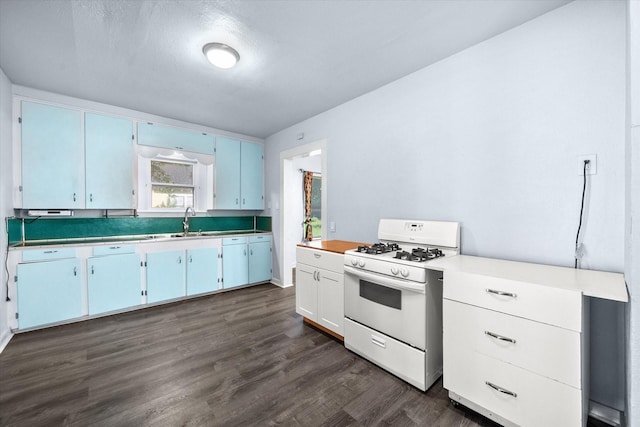 318 Mckenzie St, Waxahachie, TX 75165 - kitchen featuring white gas range oven, light countertops, and dark wood-style flooring