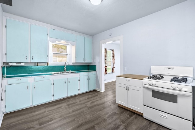 318 Mckenzie St, Waxahachie, TX 75165 - kitchen with white range with gas cooktop, dark wood-style floors, and light countertops