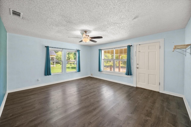 318 Mckenzie St, Waxahachie, TX 75165 - spare room with ceiling fan, dark wood finished floors, and a textured ceiling