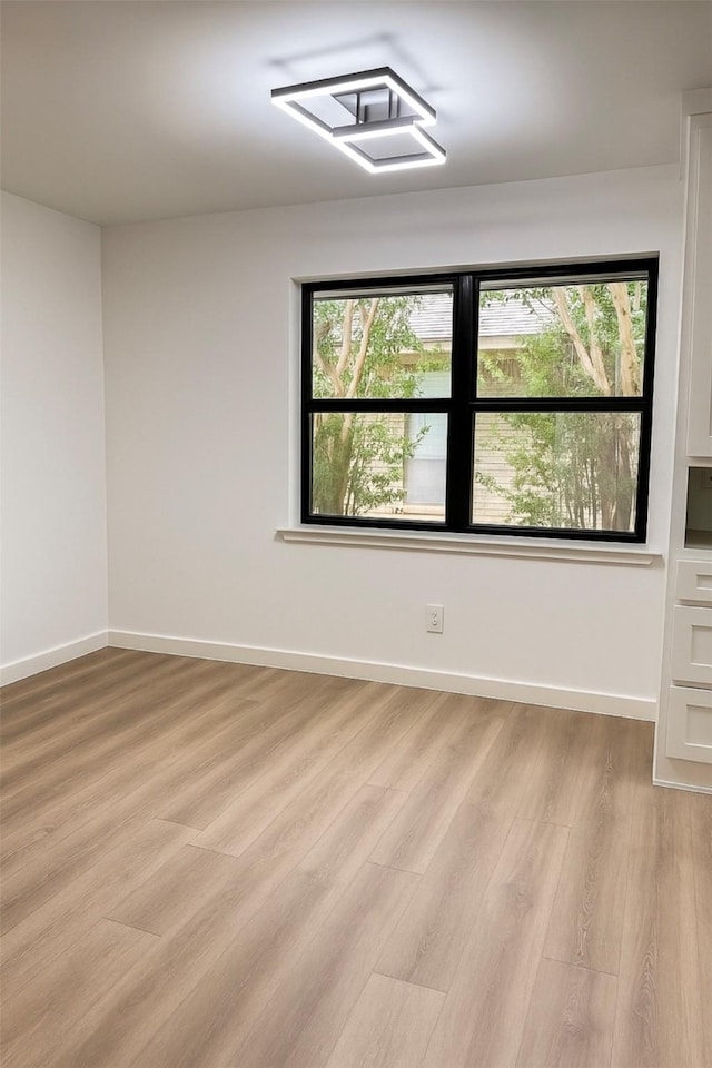 422 Birch Ln, Richardson, TX 75081 - unfurnished room featuring light wood-style floors and baseboards