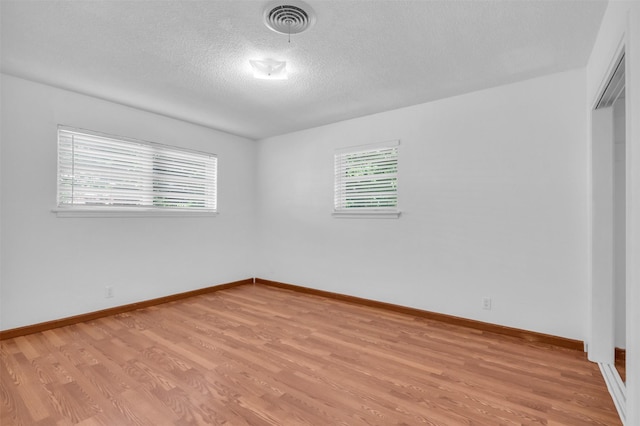 5624 Waltham Ave, Fort Worth, TX 76133 - empty room with a textured ceiling and light wood-style floors