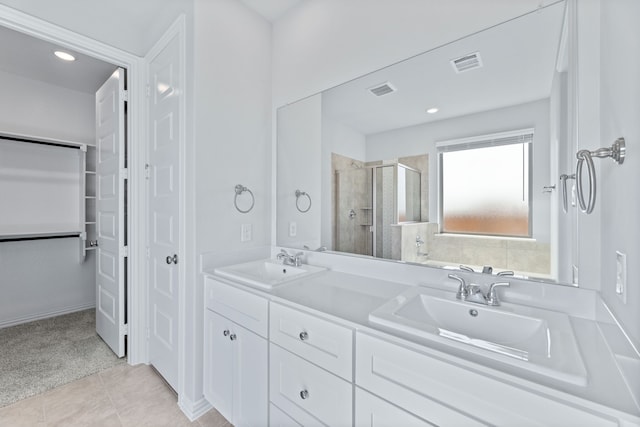 1957 Jade Forest Ln, Mesquite, TX 75181 - bathroom featuring a stall shower, double vanity, tile patterned flooring, a walk in closet, and recessed lighting
