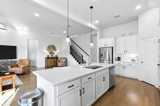 11720 Bull Creek Dr, Northlake, TX 76226 - kitchen with appliances with stainless steel finishes, dark wood-style floors, open floor plan, decorative backsplash, and recessed lighting