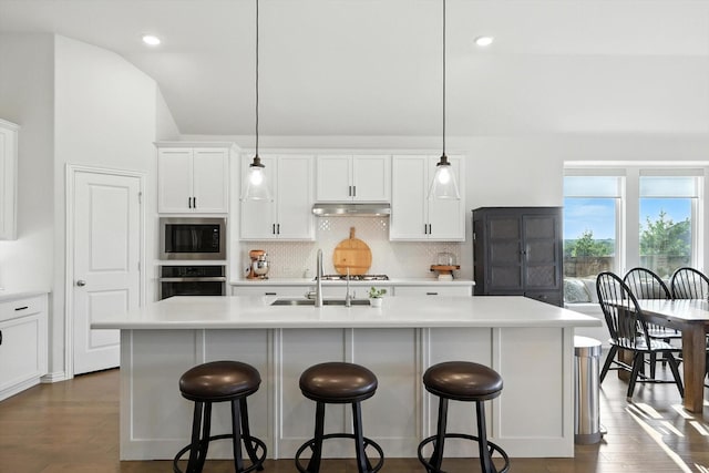 11720 Bull Creek Dr, Northlake, TX 76226 - kitchen with oven, built in microwave, under cabinet range hood, tasteful backsplash, and light countertops