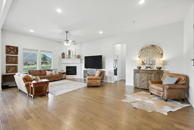 11720 Bull Creek Dr, Northlake, TX 76226 - living area featuring a glass covered fireplace, wood finished floors, a ceiling fan, and recessed lighting