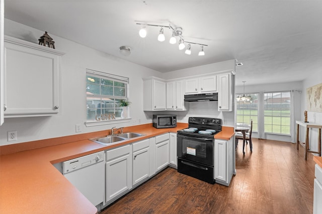 3227 Baskin Dr, Lancaster, TX 75134 - kitchen with black electric range oven, white dishwasher, stainless steel microwave, under cabinet range hood, and light countertops
