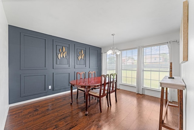 3227 Baskin Dr, Lancaster, TX 75134 - dining room featuring a chandelier, dark wood finished floors, and a decorative wall