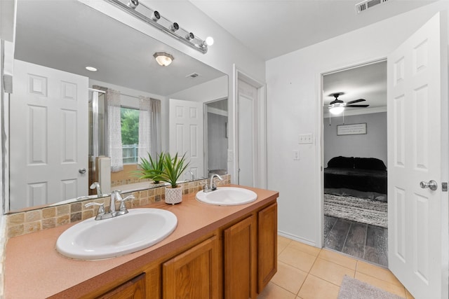 3227 Baskin Dr, Lancaster, TX 75134 - full bathroom with double vanity, tile patterned flooring, connected bathroom, ceiling fan, and backsplash