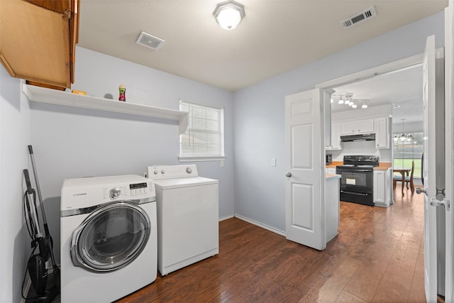 3227 Baskin Dr, Lancaster, TX 75134 - laundry area featuring washer and dryer and dark wood-style flooring