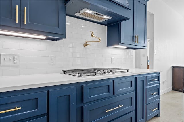177 Mel Dr, Woodway, TX 76712 - kitchen featuring blue cabinetry, exhaust hood, light countertops, and tasteful backsplash