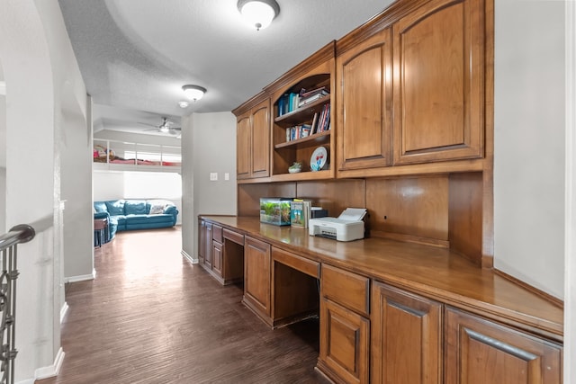 1 Cimarron Ct, Trophy Club, TX 76262 - office featuring built in study area, dark wood-style floors, a ceiling fan, and a textured ceiling