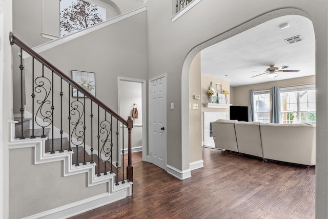 1 Cimarron Ct, Trophy Club, TX 76262 - entryway featuring arched walkways, wood finished floors, ceiling fan, and stairs