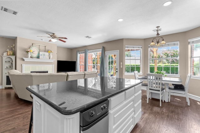 1 Cimarron Ct, Trophy Club, TX 76262 - kitchen featuring dark wood-style flooring, a tile fireplace, white cabinetry, a textured ceiling, and recessed lighting