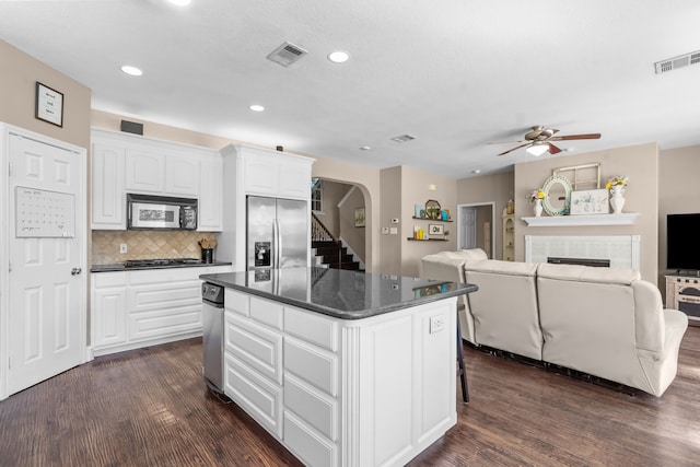 1 Cimarron Ct, Trophy Club, TX 76262 - kitchen featuring stainless steel fridge, a kitchen island, dark wood finished floors, a tile fireplace, and recessed lighting