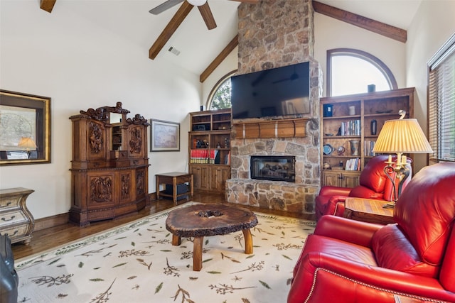 1801 Kinsale Dr, Keller, TX 76262 - living room with wood finished floors, beam ceiling, high vaulted ceiling, a ceiling fan, and a stone fireplace