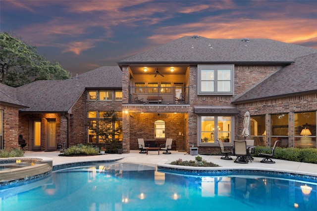 1801 Kinsale Dr, Keller, TX 76262 - back of property at dusk featuring a balcony, brick siding, a patio, and roof with shingles