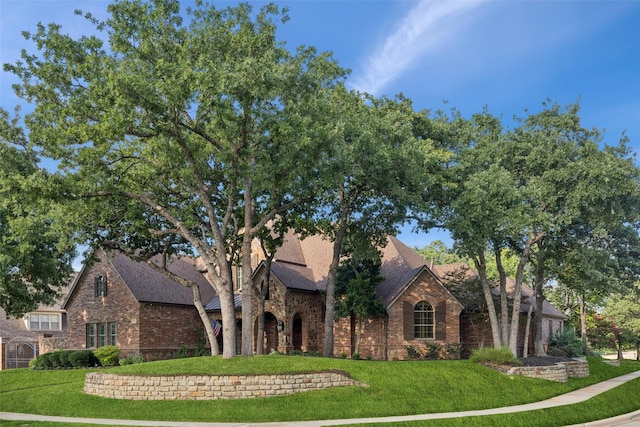 1801 Kinsale Dr, Keller, TX 76262 - tudor home with stone siding, a front yard, brick siding, and roof with shingles