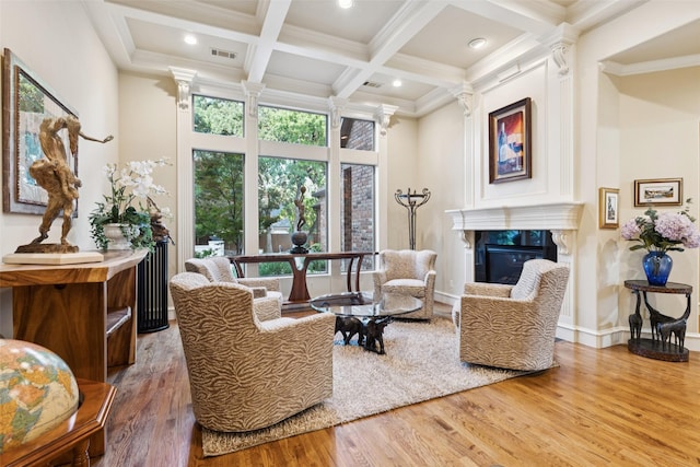 1801 Kinsale Dr, Keller, TX 76262 - living area featuring ornate columns, wood finished floors, a glass covered fireplace, coffered ceiling, and beam ceiling