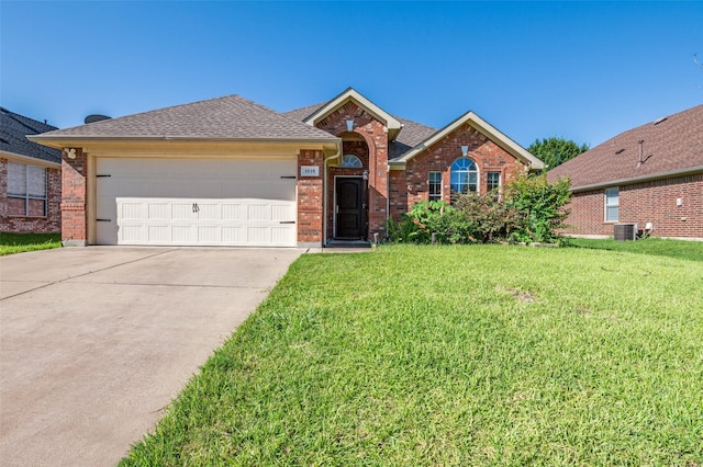 1015 Seider Ln, Grand Prairie, TX 75052 - view of front of home with brick siding, a front lawn, a garage, and driveway