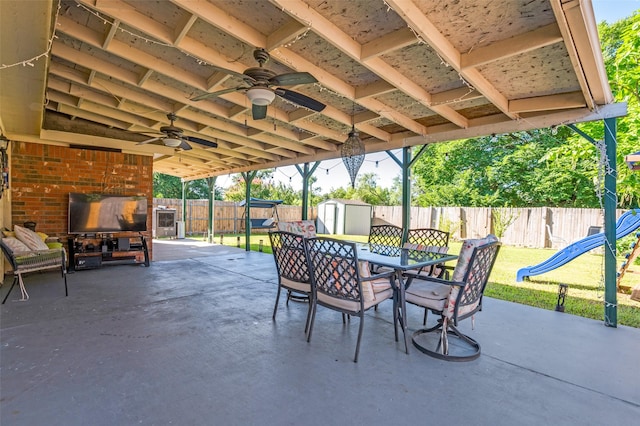 1015 Seider Ln, Grand Prairie, TX 75052 - fenced backyard with a shed, outdoor dining area, a patio, and a ceiling fan