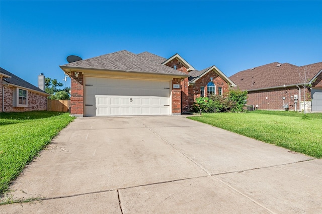 1015 Seider Ln, Grand Prairie, TX 75052 - view of front of house featuring brick siding, driveway, an attached garage, and roof with shingles
