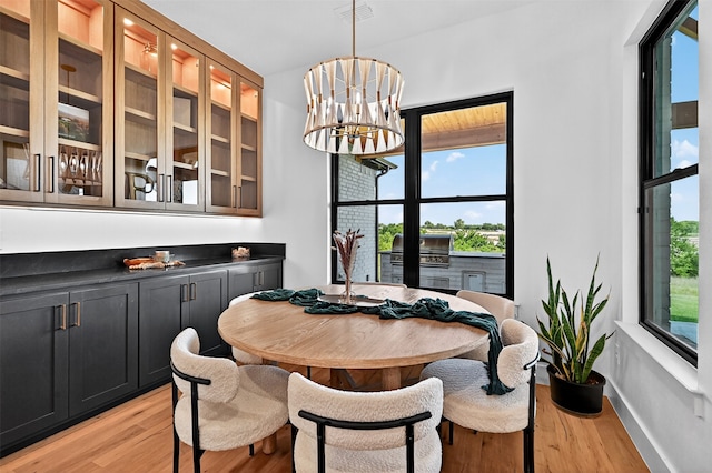 2028 Fox Bend Trce, Gunter, TX 75058 - dining area with light wood-type flooring and a chandelier