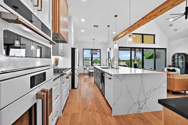 2028 Fox Bend Trce, Gunter, TX 75058 - kitchen featuring freestanding refrigerator, light wood-style flooring, recessed lighting, open floor plan, and light stone countertops