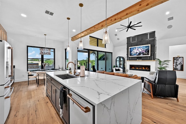 2028 Fox Bend Trce, Gunter, TX 75058 - kitchen with refrigerator with ice dispenser, beam ceiling, white dishwasher, recessed lighting, and a fireplace