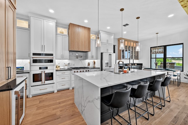 2028 Fox Bend Trce, Gunter, TX 75058 - kitchen featuring white appliances, light wood-type flooring, tasteful backsplash, a breakfast bar area, and recessed lighting