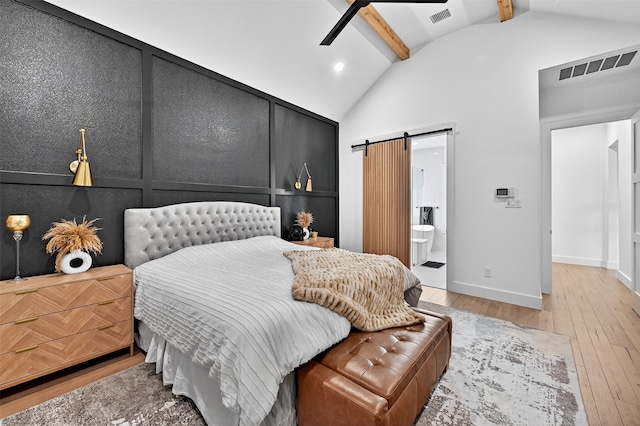 2028 Fox Bend Trce, Gunter, TX 75058 - bedroom with a barn door, light wood-style floors, and ensuite bath