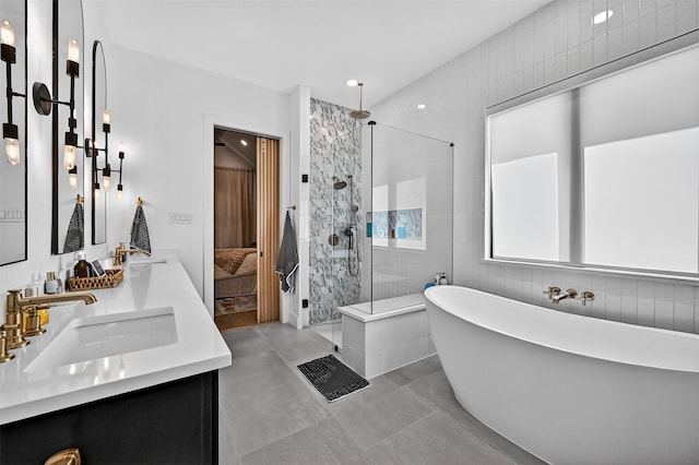 2028 Fox Bend Trce, Gunter, TX 75058 - bathroom with double vanity, a walk in shower, a freestanding bath, and tile walls