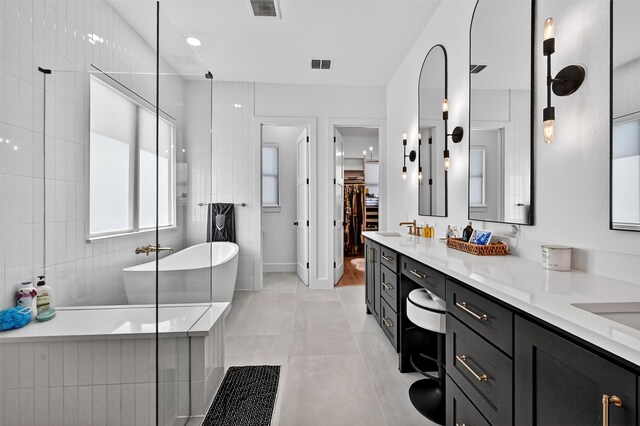 2028 Fox Bend Trce, Gunter, TX 75058 - full bathroom featuring vanity, a freestanding tub, a spacious closet, and tile patterned floors
