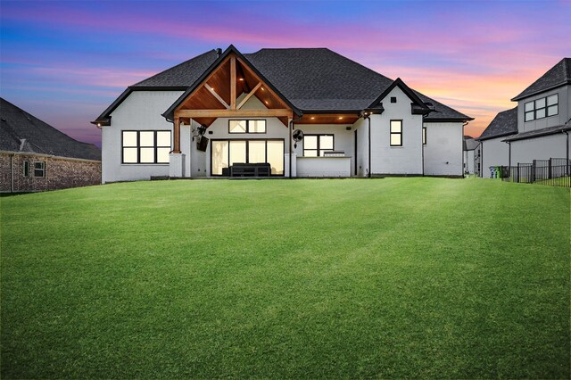 2028 Fox Bend Trce, Gunter, TX 75058 - back of property at dusk with a shingled roof and stucco siding
