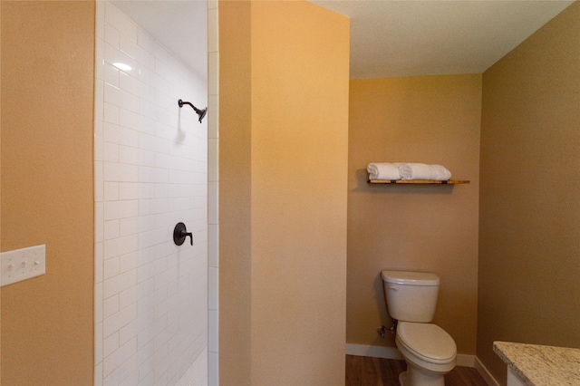 111 W Clinton Ave, Athens, TX 75751 - full bathroom with a tile shower, wood finished floors, and vanity