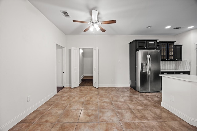 4816 Club View Cir, Mesquite, TX 75150 - kitchen featuring stainless steel fridge, a ceiling fan, light countertops, dark cabinetry, and backsplash