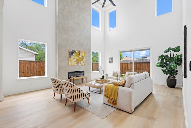 1706 Homeland St, Dallas, TX 75212 - living area with a high ceiling, light wood-style floors, a fireplace, plenty of natural light, and ceiling fan