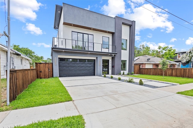 1706 Homeland St, Dallas, TX 75212 - contemporary house with a balcony, driveway, stucco siding, and an attached garage