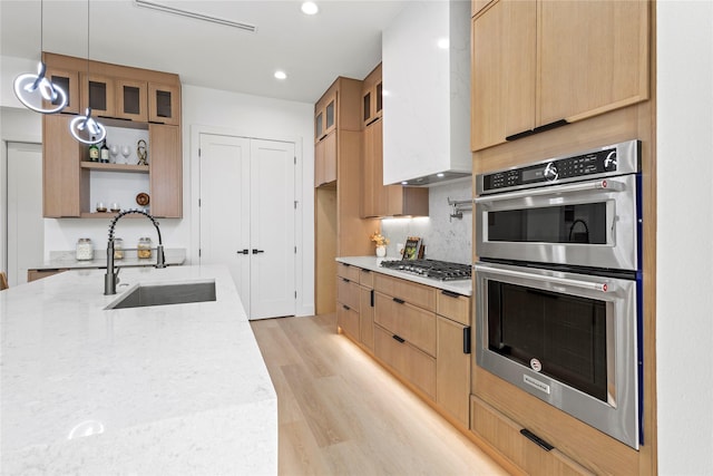 1706 Homeland St, Dallas, TX 75212 - kitchen with stainless steel appliances, open shelves, light wood-style floors, glass insert cabinets, and recessed lighting