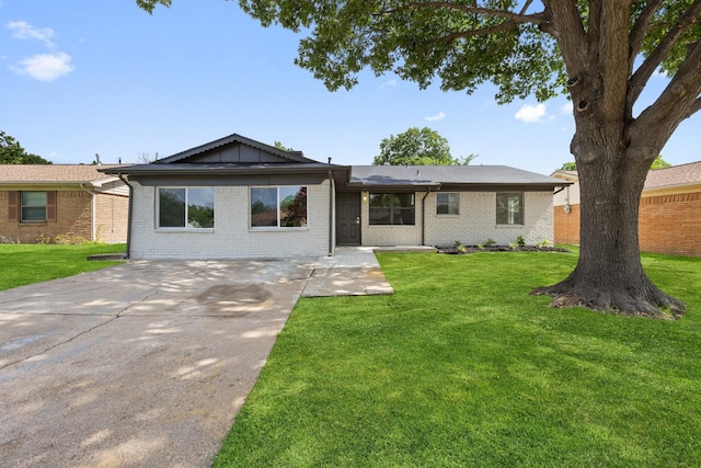 719 Sara Dr, Mesquite, TX 75149 - ranch-style home featuring a front lawn, driveway, and brick siding