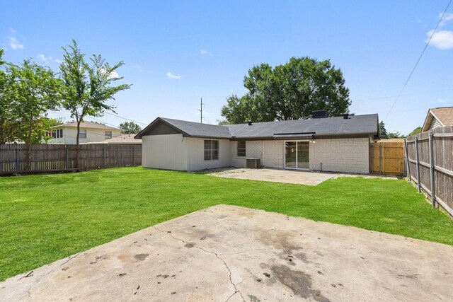 719 Sara Dr, Mesquite, TX 75149 - back of house featuring a patio area, a fenced backyard, and brick siding