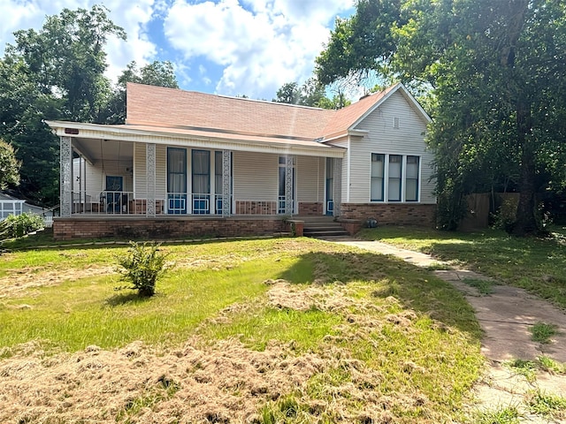 1915 N Jackson St, Palestine, TX 75803 - ranch-style house featuring a porch, a front yard, and brick siding