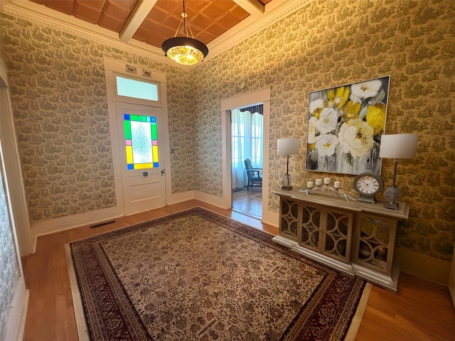 1915 N Jackson St, Palestine, TX 75803 - entryway featuring wood finished floors, ornamental molding, beam ceiling, and coffered ceiling