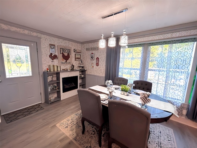 1915 N Jackson St, Palestine, TX 75803 - dining space with a wainscoted wall, wood finished floors, and wallpapered walls