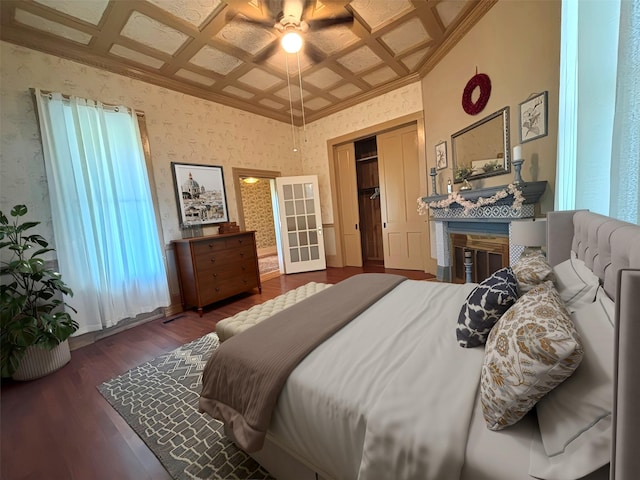 1915 N Jackson St, Palestine, TX 75803 - bedroom featuring coffered ceiling, wood finished floors, crown molding, a fireplace, and ceiling fan