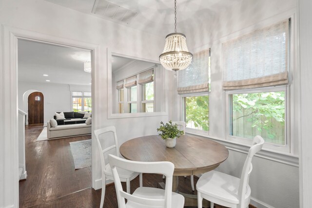 3216 Lovers Ln, University Park, TX 75225 - dining area with dark wood finished floors, a chandelier, and arched walkways