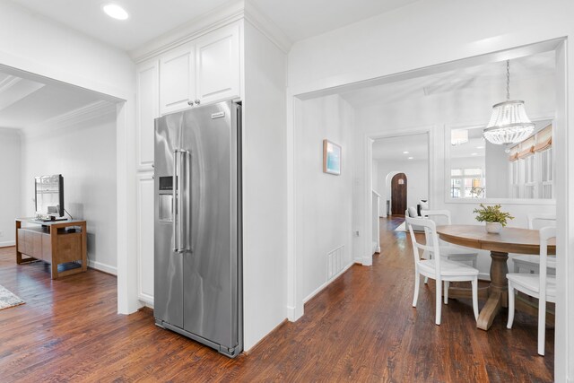 3216 Lovers Ln, University Park, TX 75225 - kitchen with high end refrigerator, dark wood-style flooring, white cabinetry, a chandelier, and arched walkways