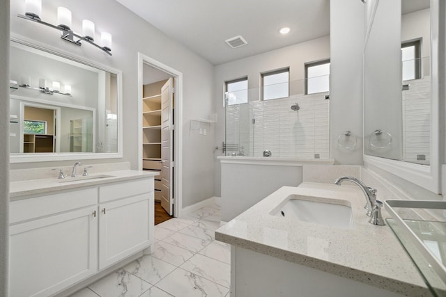 13313 Rembrandt Dr, Frisco, TX 75035 - bathroom featuring marble look tiles, two vanities, walk in shower, a spacious closet, and recessed lighting